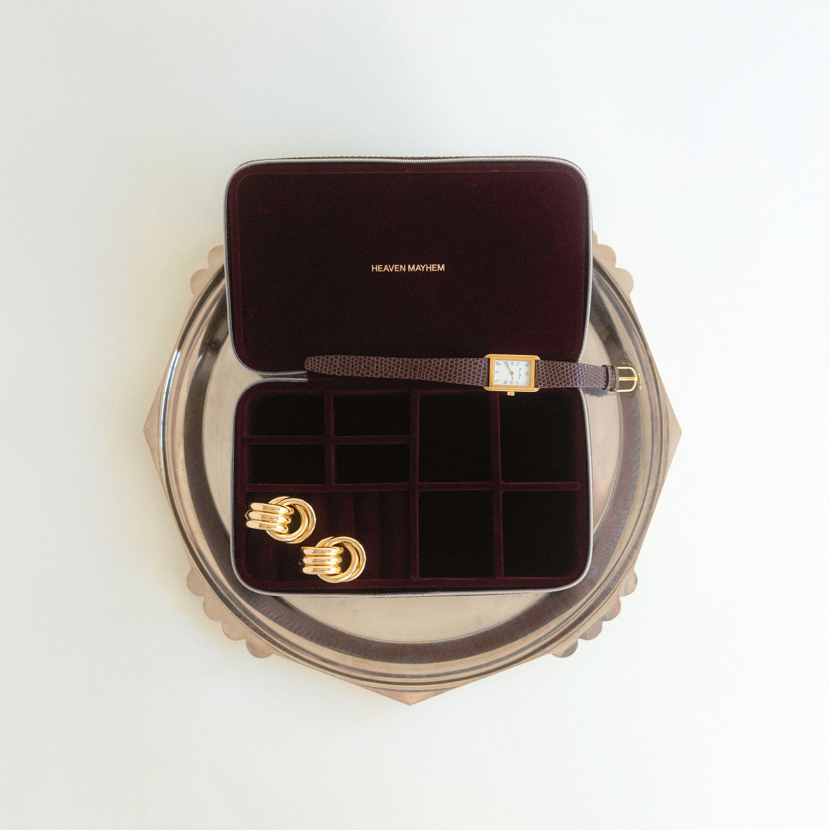 Jewelry box with gold earrings on a white background